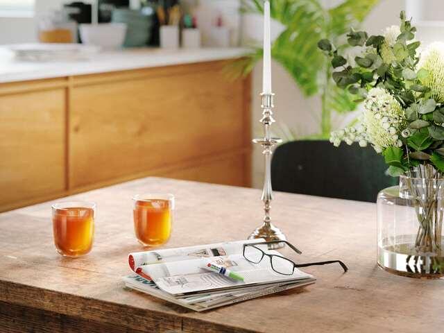 Bostik Super Glue Ultra+ adhesive on a table with magazines and glasses for quick repairs.