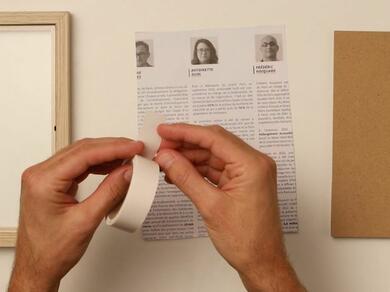 A scrapbook being decorated with cut-out images and Glu Dots.