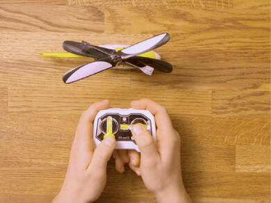 Repaired toy helicopter placed back with its remote control ready for play