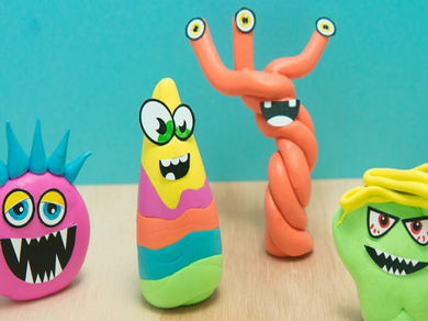 Completed Blu Tack monsters in playful shapes and colours, each with unique eyes and expressions, ready for imaginative play.
