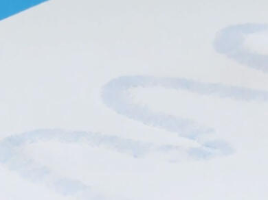 White paper with visible light-blue glue marks forming curved letters using Bostik Blu Stik adhesive.