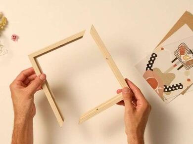 Hands assembling a wooden picture frame for repair with Bostik adhesive.