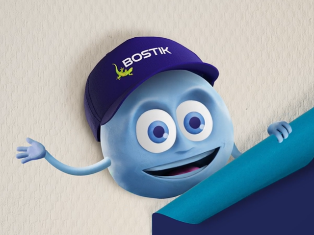 Bostik mascot character Tacky emerging with excitement amid colorful balloons and confetti—representing news, events, and blog updates.