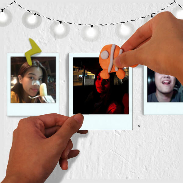 Instant photos are displayed on a wall, secured with colourful Blu Tack decorations including a fish and lightning bolt shape.