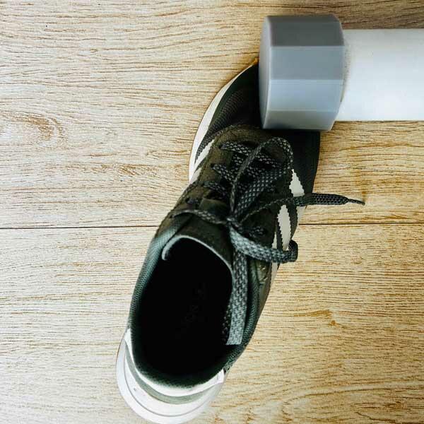 Pressing the sneaker sole together to ensure a strong bond after gluing.