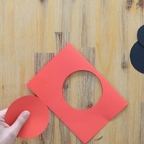 The red wings are cut out of red cardstock using a circular template.