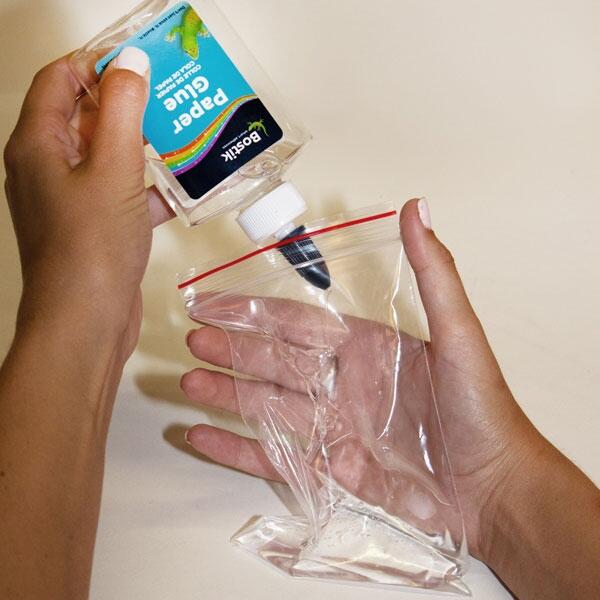 Pouring clear Bostik Paper Glue into a resealable plastic bag to start the magical ocean mix.