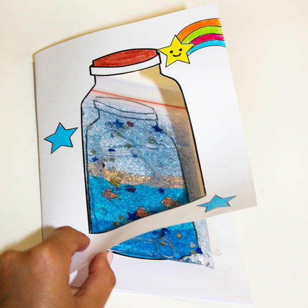 Lifting the cut-out jar flap to reveal the sparkling, ocean-inspired bag peeking through underneath.