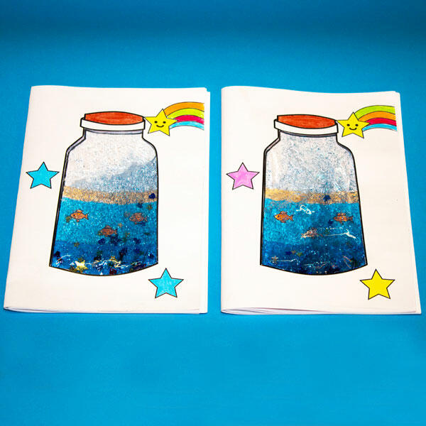 A proud final look at two completed ocean notebooks, sparkling with fish, glitter, and DIY magic