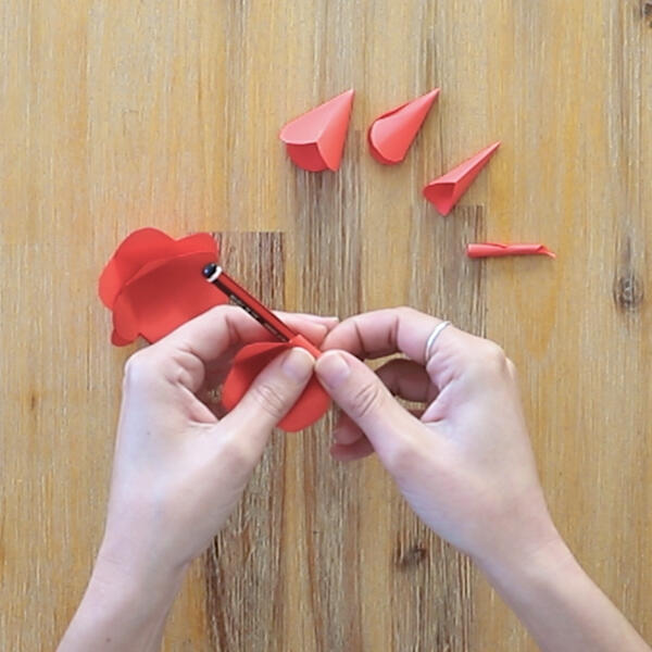 Curling the edges of the petals around a pencil to give the flower a natural look.