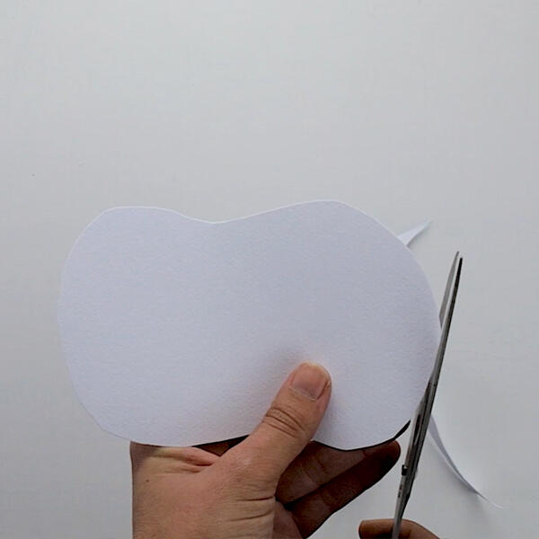 Cutting out the base of the Pinguin from white paper.