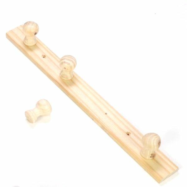 Wall-mounted wooden coat rack shown fully assembled with four pegs and a hanging weight, demonstrating durability after repair.