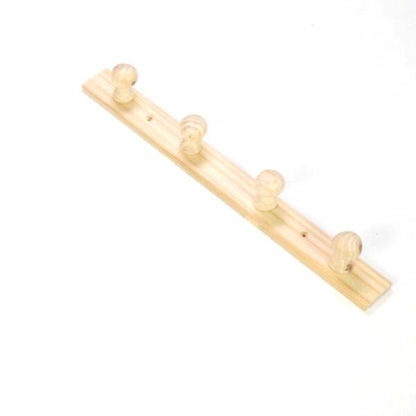 Close-up of the repaired peg on the wooden coat rack, successfully reattached with glue.