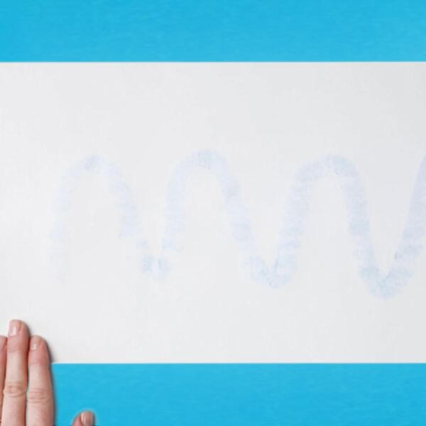 White sheet of paper with faint blue adhesive marks from a Bostik Blu Stik application.