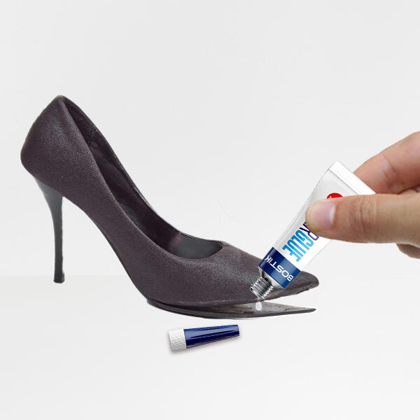 Close-up of Bostik Leather Glue being applied to reattach the sole of a black high heel shoe.