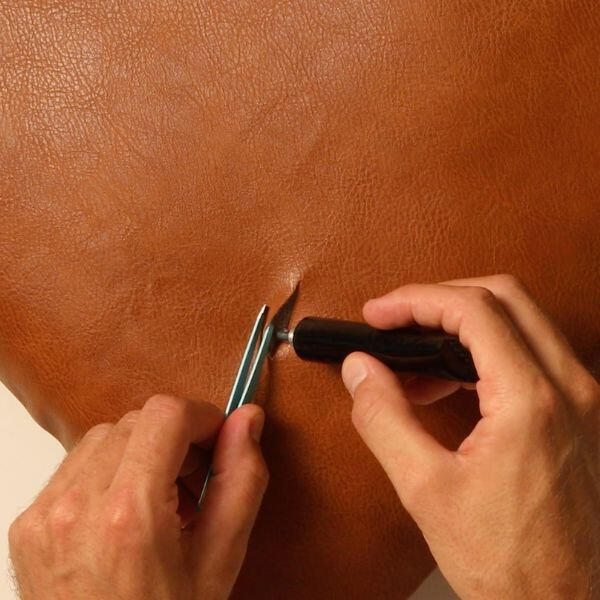 Brown leather cushion with tear fully repaired using Bostik Leather Glue.
