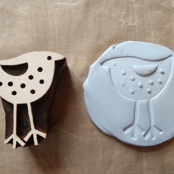 Wooden bird stamp and matching Blu Tack impression shown side by side.