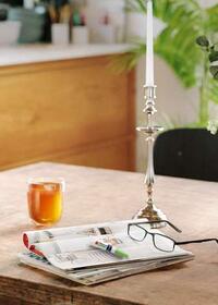 Bostik Super Glue Ultra+ adhesive on a table with magazines and glasses for quick repairs.